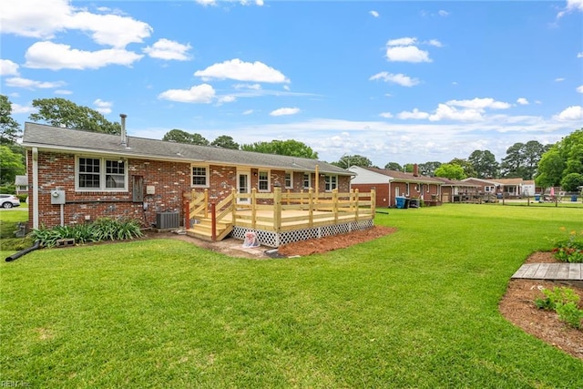 3435 Macdonald Rd, Virginia Beach, VA 23464 - back of property featuring central air condition unit, a deck, a yard, and brick siding