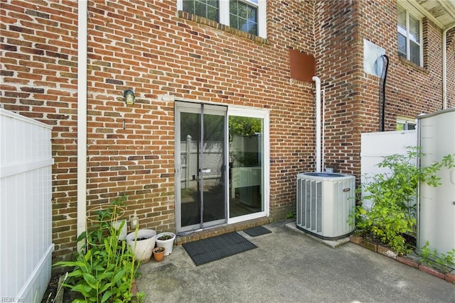 882 Elizabeth Ct, Virginia Beach, VA 23451 - entrance to property with central AC unit, brick siding, and a patio