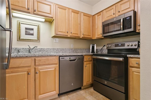 113 Pelhams Ordinary, Williamsburg, VA 23185 - kitchen featuring stainless steel appliances, a sink, light stone counters, and light brown cabinets