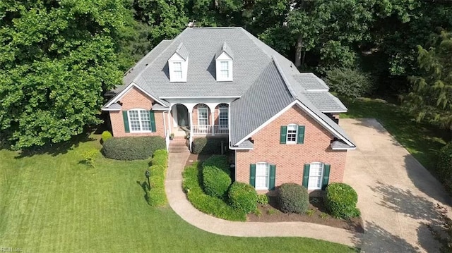 20531 Madison Ct, Smithfield, VA 23430 - view of front facade with brick siding, a front lawn, covered porch, and driveway