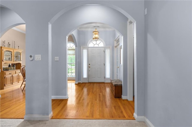 20531 Madison Ct, Smithfield, VA 23430 - foyer featuring baseboards, crown molding, wood finished floors, and arched walkways