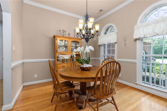 20531 Madison Ct, Smithfield, VA 23430 - dining space featuring light wood finished floors, a chandelier, baseboards, plenty of natural light, and ornamental molding