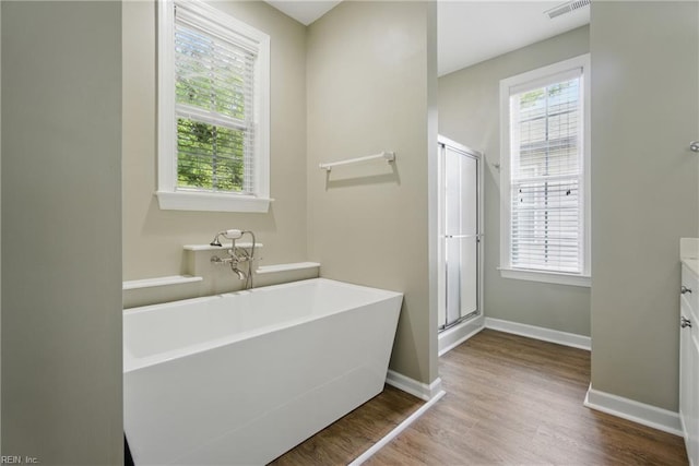 460 Blue Beech Way Unit 963, Chesapeake, VA 23320 - bathroom featuring wood finished floors, a freestanding bath, vanity, a stall shower, and baseboards
