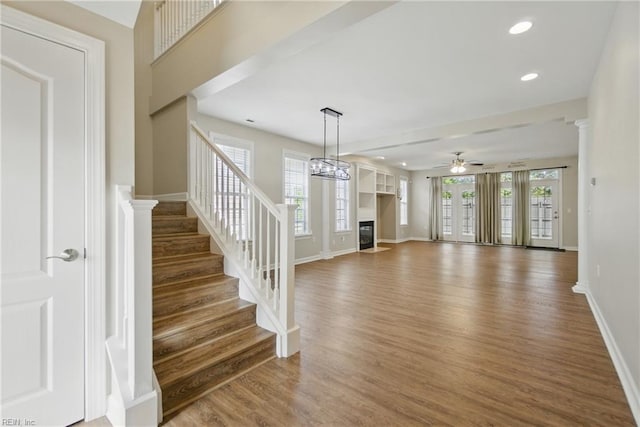 460 Blue Beech Way Unit 963, Chesapeake, VA 23320 - unfurnished living room featuring a glass covered fireplace, a ceiling fan, wood finished floors, baseboards, and stairway