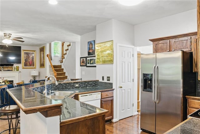 127 Rockland Ter, Suffolk, VA 23434 - kitchen with stainless steel fridge, a sink, white dishwasher, tile countertops, and a kitchen bar