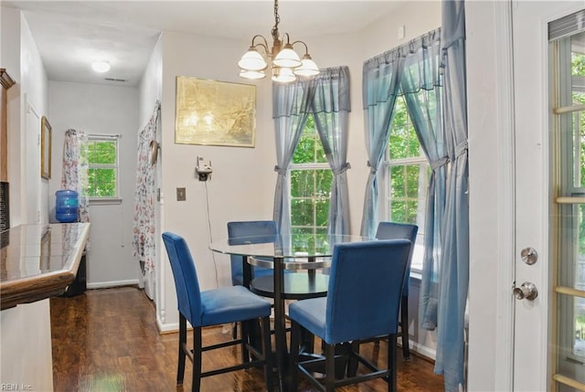 127 Rockland Ter, Suffolk, VA 23434 - dining area with dark wood finished floors, healthy amount of natural light, a chandelier, and baseboards