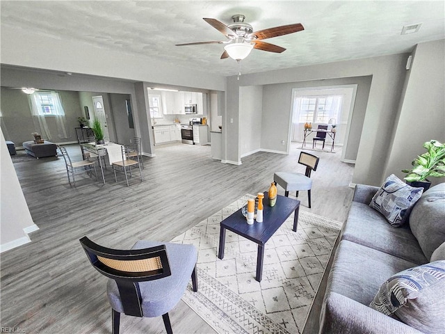 865 Kings Arms Dr, Virginia Beach, VA 23452 - living room featuring baseboards, ceiling fan, and light wood-style floors