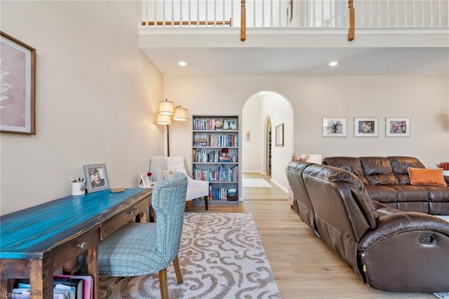 6 Lessies Dr, Poquoson, VA 23662 - living area featuring arched walkways, wood finished floors, a towering ceiling, and recessed lighting