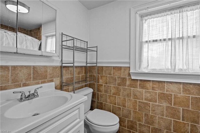 811 Wingfield Ave, Chesapeake, VA 23325 - bathroom with toilet, vanity, tile walls, curtained shower, and a wainscoted wall