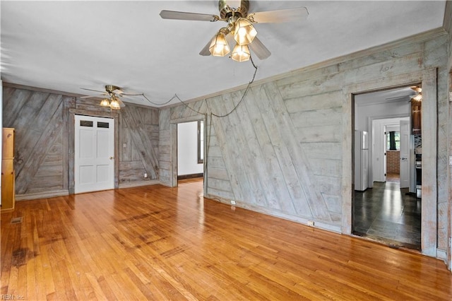 811 Wingfield Ave, Chesapeake, VA 23325 - spare room featuring ceiling fan, wood walls, crown molding, wood finished floors, and baseboards