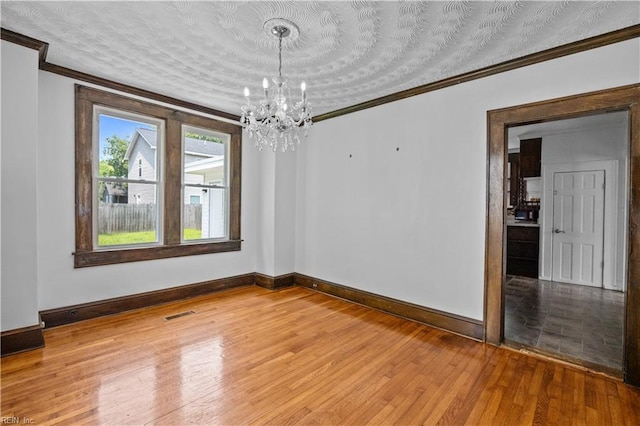 811 Wingfield Ave, Chesapeake, VA 23325 - empty room featuring crown molding, a chandelier, baseboards, and light wood finished floors