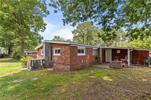 1208 Santeetlah Ave, Chesapeake, VA 23325 - back of house with a yard, central AC unit, and brick siding
