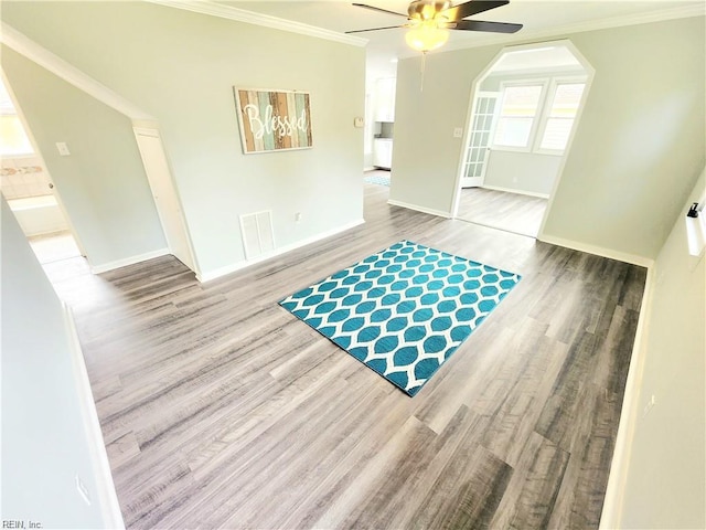 619 City Park Ave, Portsmouth, VA 23701 - unfurnished room with wood finished floors, ceiling fan, baseboards, ornamental molding, and arched walkways