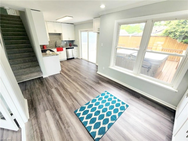 619 City Park Ave, Portsmouth, VA 23701 - kitchen with dishwasher, ornamental molding, dark wood-type flooring, white cabinets, and decorative backsplash