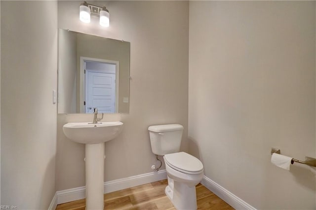 515 Buckroe Ave, Hampton, VA 23664 - bathroom featuring toilet, wood finished floors, baseboards, and a sink