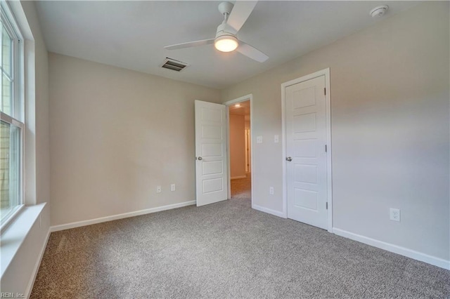 515 Buckroe Ave, Hampton, VA 23664 - unfurnished bedroom with carpet, multiple windows, baseboards, and a ceiling fan
