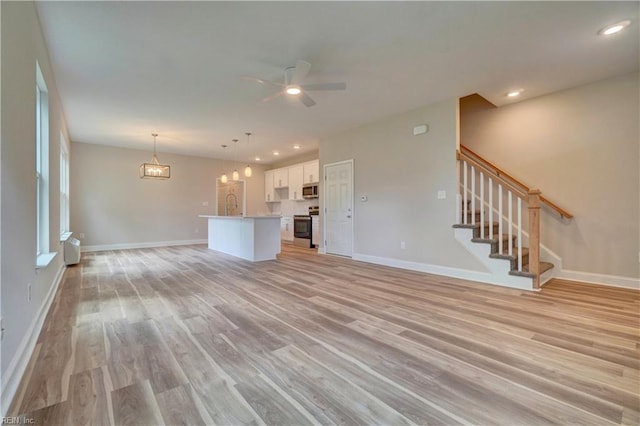 515 Buckroe Ave, Hampton, VA 23664 - unfurnished living room with light wood finished floors, a ceiling fan, stairs, baseboards, and recessed lighting