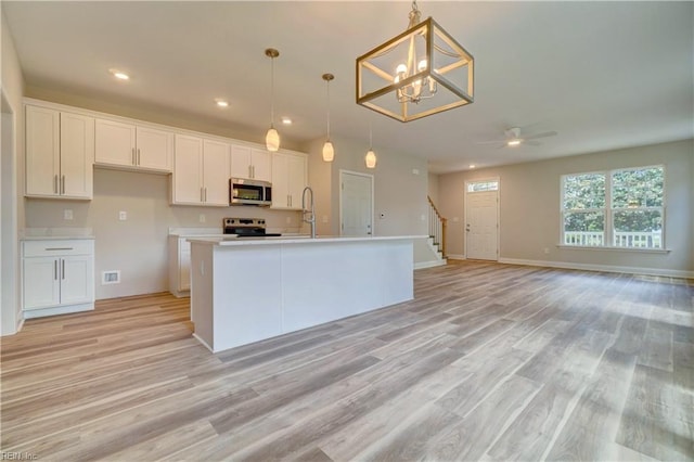 515 Buckroe Ave, Hampton, VA 23664 - kitchen featuring stainless steel microwave, electric range, white cabinets, light wood-type flooring, and recessed lighting