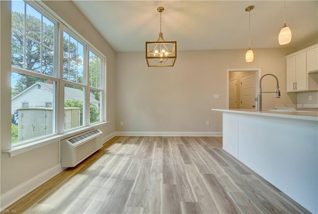 515 Buckroe Ave, Hampton, VA 23664 - kitchen featuring a wall mounted AC, a chandelier, light wood-style floors, and baseboards