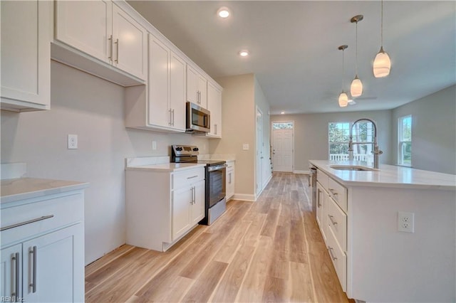 515 Buckroe Ave, Hampton, VA 23664 - kitchen featuring stainless steel appliances, a sink, light wood-style flooring, light countertops, and recessed lighting