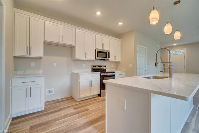 515 Buckroe Ave, Hampton, VA 23664 - kitchen featuring appliances with stainless steel finishes, light wood-type flooring, white cabinetry, a sink, and decorative light fixtures