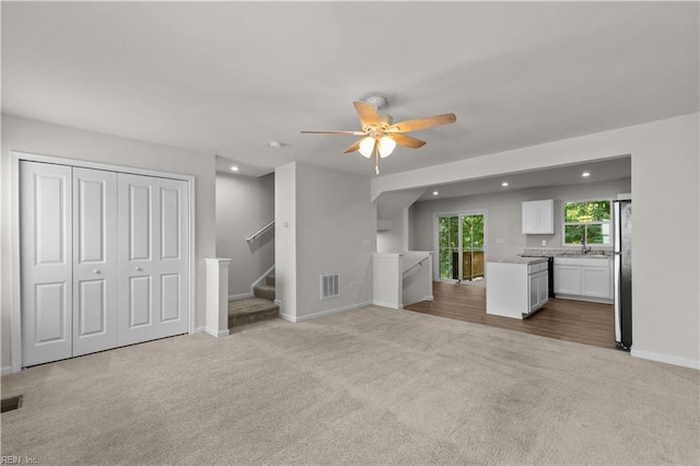 1102 Lakeview Cv, Smithfield, VA 23430 - unfurnished living room featuring carpet, recessed lighting, a ceiling fan, a sink, and stairs