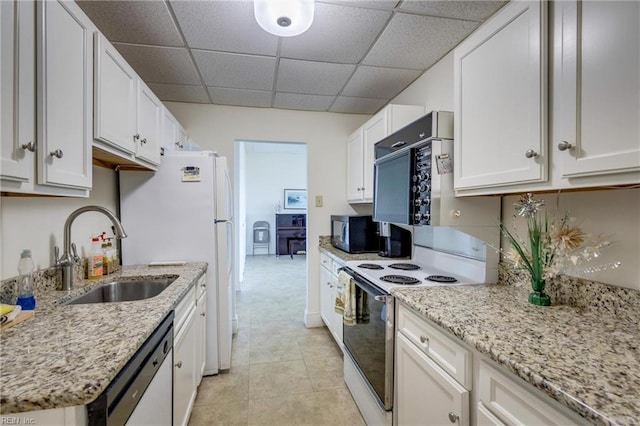 2830 Shore Dr Unit 1006, Virginia Beach, VA 23451 - kitchen featuring white appliances, a sink, white cabinetry, a paneled ceiling, and light stone counters