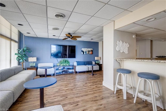 2830 Shore Dr Unit 1006, Virginia Beach, VA 23451 - living area featuring a paneled ceiling, wood finished floors, ceiling fan, and baseboards