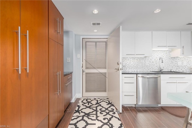2830 Shore Dr Unit 1006, Virginia Beach, VA 23451 - kitchen featuring dishwasher, a sink, dark wood-type flooring, backsplash, and dark countertops