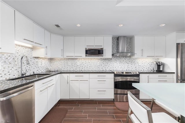 2830 Shore Dr Unit 1006, Virginia Beach, VA 23451 - kitchen with wall chimney range hood, stainless steel appliances, a sink, dark wood-style floors, and dark countertops