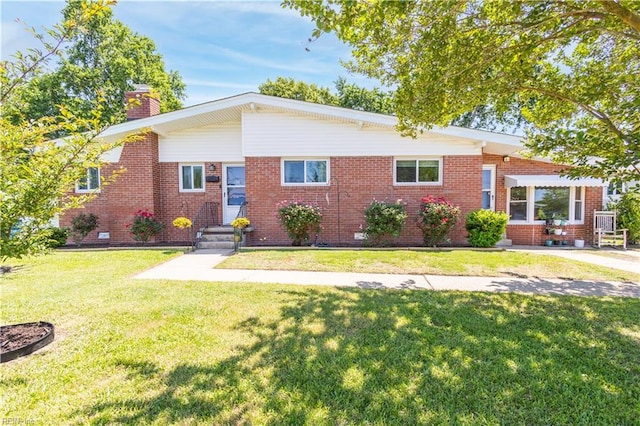 708 Houdon Ln, Virginia Beach, VA 23455 - view of front facade with a chimney, brick siding, and a front yard