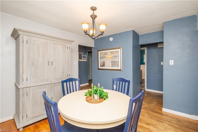 708 Houdon Ln, Virginia Beach, VA 23455 - dining room featuring a chandelier, light wood-type flooring, baseboards, and a textured ceiling