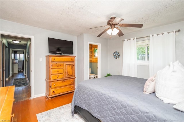708 Houdon Ln, Virginia Beach, VA 23455 - bedroom with wood finished floors, a textured ceiling, baseboards, a ceiling fan, and ensuite bathroom