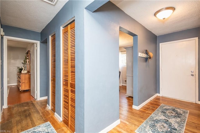 708 Houdon Ln, Virginia Beach, VA 23455 - entrance foyer with a textured ceiling, wood finished floors, and baseboards
