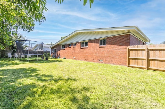 708 Houdon Ln, Virginia Beach, VA 23455 - back of house with a trampoline, brick siding, and crawl space