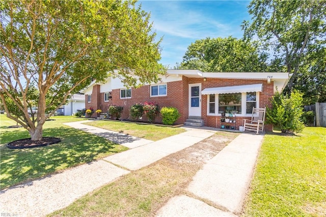 708 Houdon Ln, Virginia Beach, VA 23455 - view of front of home featuring brick siding, a front yard, and entry steps