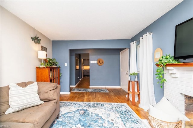 708 Houdon Ln, Virginia Beach, VA 23455 - living area with wood finished floors, a brick fireplace, and baseboards