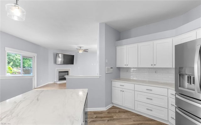 2129 Bierce Dr, Virginia Beach, VA 23454 - kitchen with stainless steel fridge with ice dispenser, ceiling fan, tasteful backsplash, white cabinets, and light stone counters