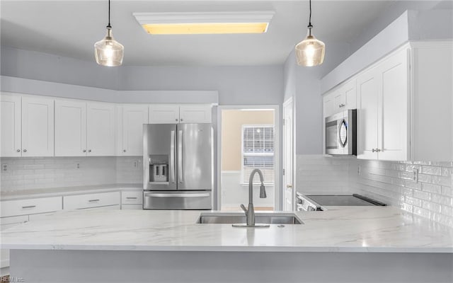 2129 Bierce Dr, Virginia Beach, VA 23454 - kitchen featuring appliances with stainless steel finishes, a sink, decorative light fixtures, and white cabinetry