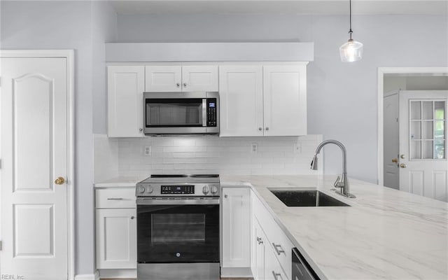 2129 Bierce Dr, Virginia Beach, VA 23454 - kitchen featuring appliances with stainless steel finishes, a sink, backsplash, white cabinets, and light stone countertops