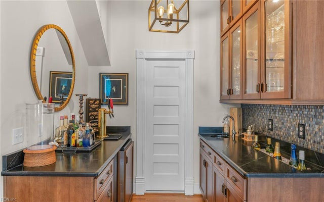 5312 Studeley Ave, Norfolk, VA 23508 - indoor dry bar with tasteful backsplash, beverage cooler, a chandelier, hanging light fixtures, and light wood-type flooring
