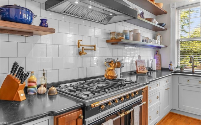 5312 Studeley Ave, Norfolk, VA 23508 - kitchen with open shelves, high end stove, wall chimney exhaust hood, and a sink