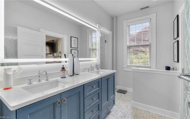 5312 Studeley Ave, Norfolk, VA 23508 - bathroom with double vanity, tile patterned floors, and baseboards