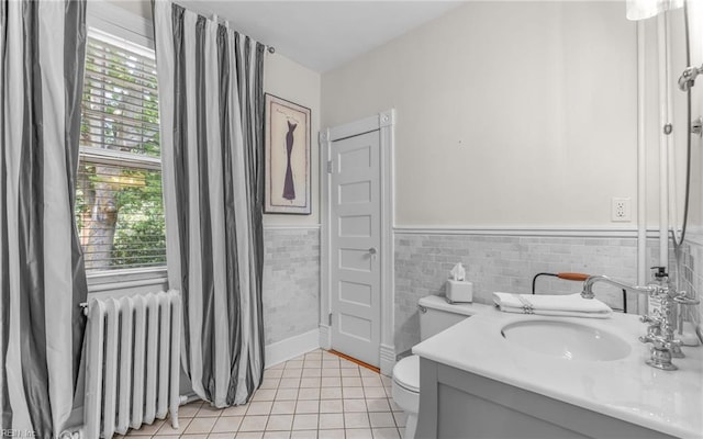 5312 Studeley Ave, Norfolk, VA 23508 - bathroom with radiator heating unit, tile patterned floors, toilet, vanity, and a wainscoted wall