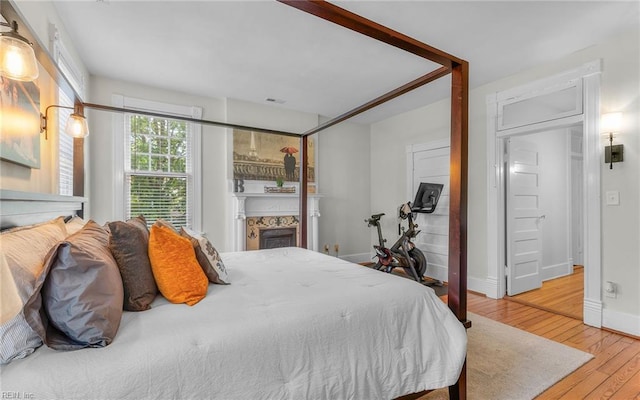 5312 Studeley Ave, Norfolk, VA 23508 - bedroom featuring wood finished floors, a fireplace, and baseboards