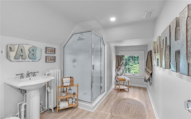 5312 Studeley Ave, Norfolk, VA 23508 - bathroom with radiator, wood finished floors, lofted ceiling, a stall shower, and a sink