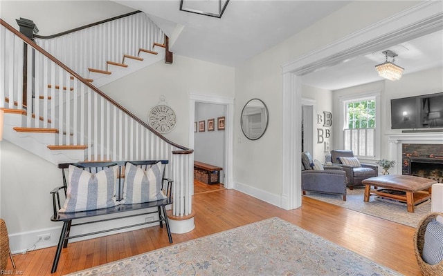 5312 Studeley Ave, Norfolk, VA 23508 - stairway featuring wood finished floors, baseboards, and a stone fireplace