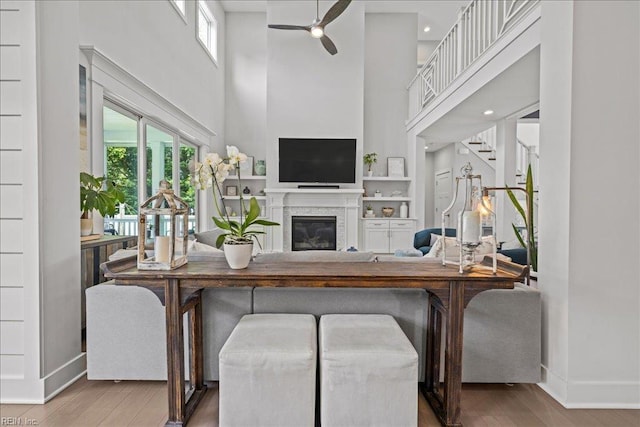 909 Los Colonis Dr, Virginia Beach, VA 23456 - living room with a high ceiling, wood finished floors, ceiling fan, baseboards, and a glass covered fireplace