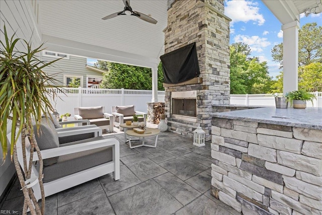 909 Los Colonis Dr, Virginia Beach, VA 23456 - fenced backyard featuring a patio, an outdoor living space with a fireplace, and a ceiling fan