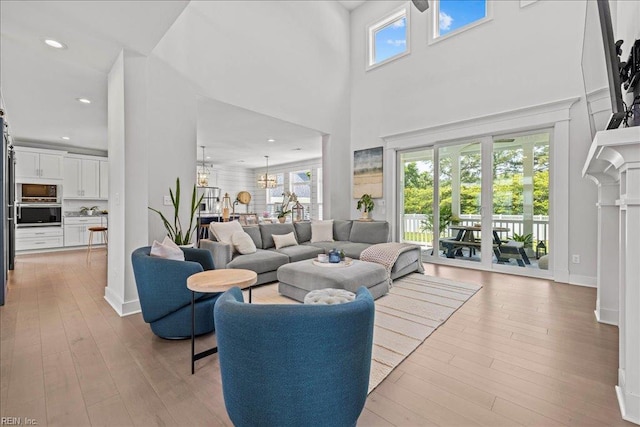 909 Los Colonis Dr, Virginia Beach, VA 23456 - living room featuring wood-type flooring, recessed lighting, a high ceiling, a chandelier, and baseboards